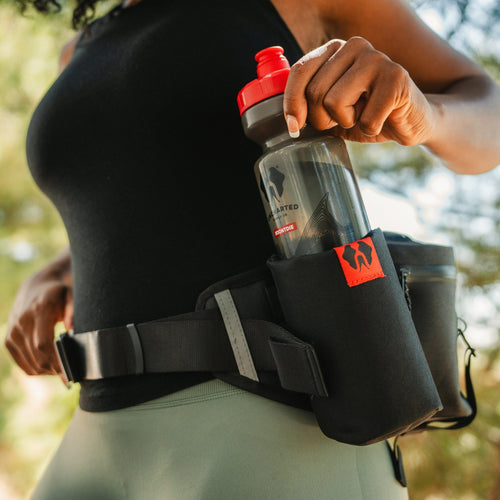 hiker wearing a park pack taking out one of the water bottles
