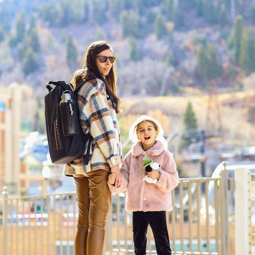 Mother and daughter holding hands, mother is wearing the seventy2 core