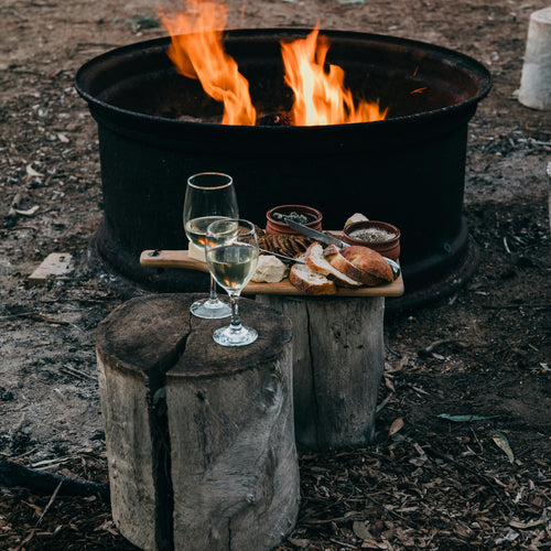 Black Beard Fire Plugs fire starter tinder for a cozy outdoor campfire. Wine and snacks on wood stumps