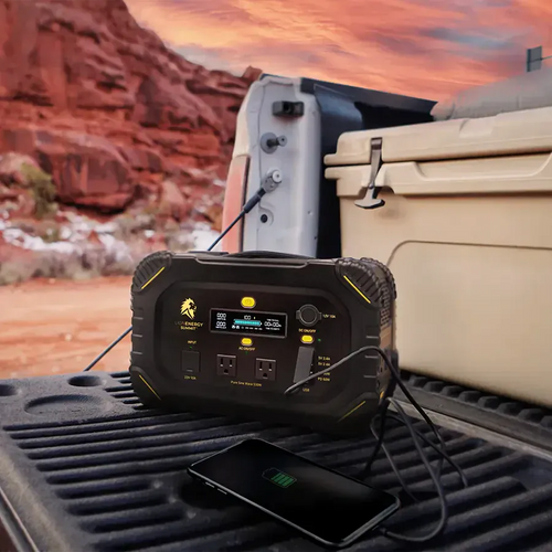 RECERTIFIED Lion Summit portable power station, black/yellow, charging phone in a truck for off-grid use