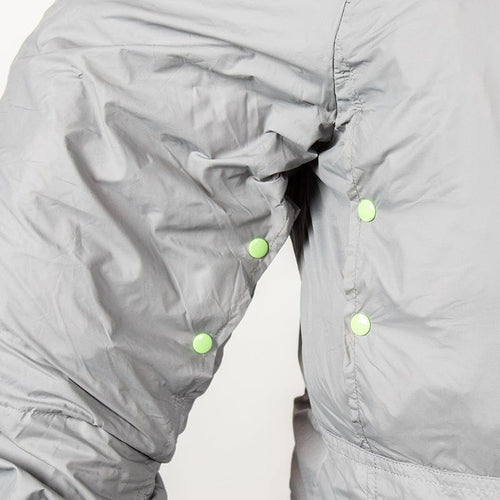 The Hideaway weather-resistant windbreaker, grey lightweight fabric with green snap buttons