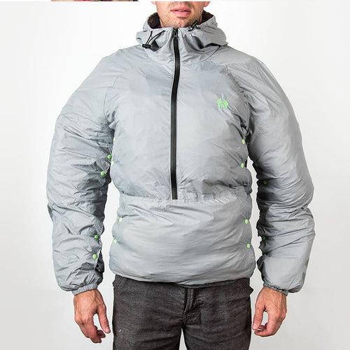 The Hideaway Weather-Resistant Windbreaker, gray hooded anorak with bright green snaps, worn by a man