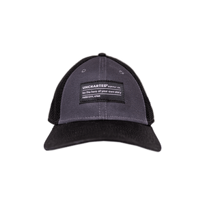 Mesh Trucker Hat by Uncharted Supply Co. Dark gray front panel, black mesh, and black brim with slogan patch