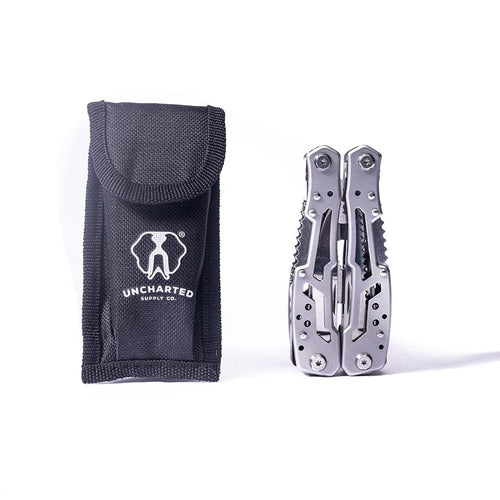 Multitool Pro, silver metal tool folded next to a black Uncharted Supply Co. survival gear pouch