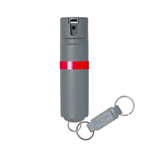 POM Pepper Spray gray self-defense device with red stripe and 'POM' keychain