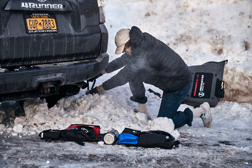 Uncharted Supply Co. survival Shovel/Axe clearing snow from under Toyota 4Runner