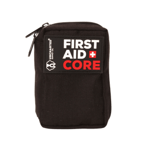 A black first aid kit with the label 'FIRST AID CORE' written in white and red on the front.